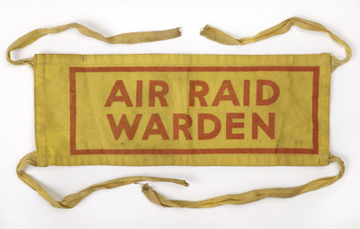 Early war Air Raid Warden armband fitted with cotton tapes (Birmingham Museum)