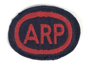 Woven red ARP letters on grosgrain